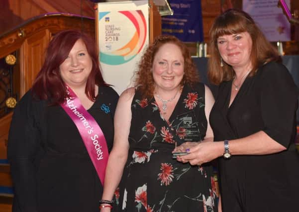 Debbie Briggs, from Rose Lodge Care Home, Lisburn, is presented with the Healthcare Assistant of the Year trophy, by Fiona McAnespie from the category sponsor Radius Housing, at the Staff Nursing Care Awards. Looking on is Laura Summerbell from the Alzheimers Society.