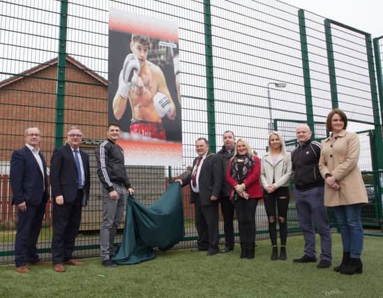 Mayor Maoliosa McHugh with local professional boxer Connor Coyle unveiling his portrait which is one of four sporting heroes portraits on permanent display at Leafair 3G pitch. Included, on left, are the Housing Executives Good Relations Officer Eddie Breslin, with Area Manager Eddie Doherty, and, from right, Cllr Caoimhe McKnight, Liam McLaughlin (boxing coach), Eva Vipartaite, Cllr Sandra Duffy, and Cllr Brian Tierney.