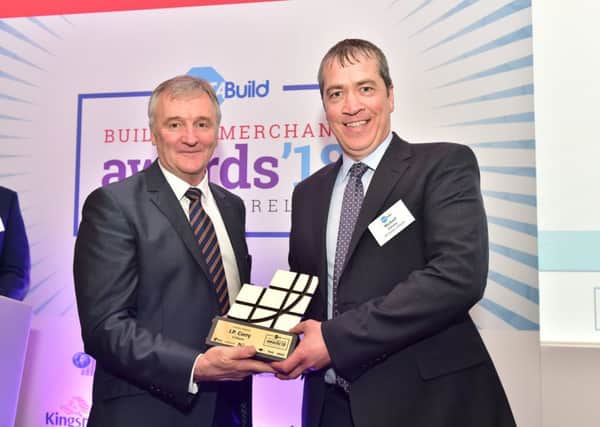 JP Corry Lisburn has been crowned the top builders merchants in Northern Ireland. Branch manager Michael Gilvary (right) receives the award from Declan Smyth of Octabuild.