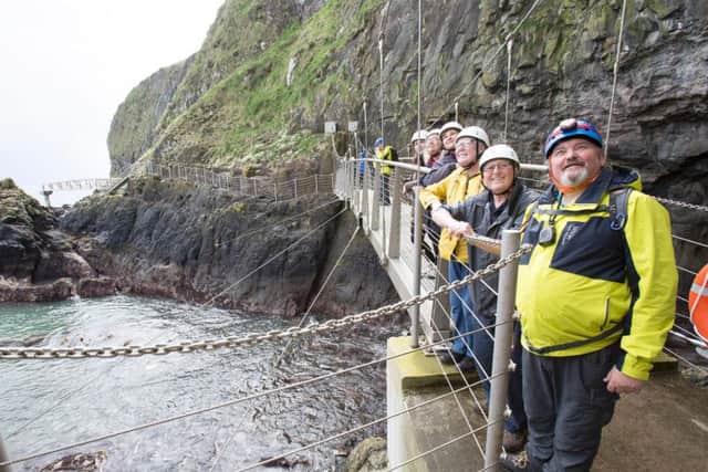 Tour guide Davie Moore (right) leads a group around the Gobbins cliff path. Photo by Paul Faith