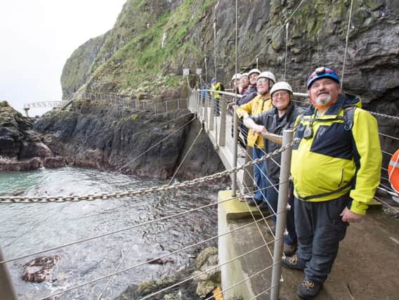Tour guide Davie Moore (right) leads a group around the Gobbins cliff path.  Photo by Paul Faith
