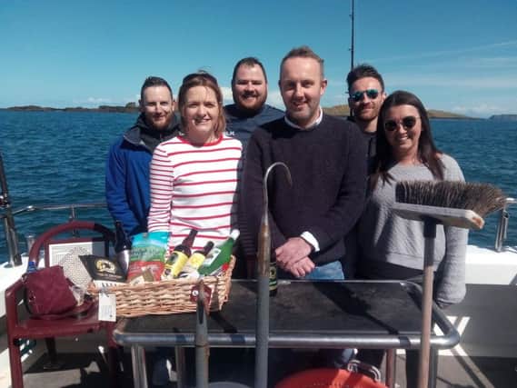 Casueway Coast Foodie Tours creator Wendy Gallagher (second from left) and skipper of the Causeway Lass, Richard Connor (third from right), with some of the guests on the 'Taste of Portrush' tour.