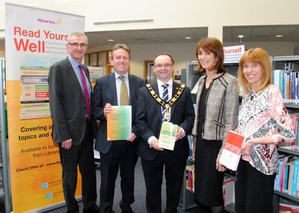 Dr Tony Stevens Chief Executive Northern Health and Social Care Trust, Jim OHagan Chief Executive Libraries NI, Councillor Paul Hamill Mayor of Antrim and Newtownabbey Council, Elaine ODoherty Public Health Agency, and Pat Smyth Health and Social Care Board pictured browsing the new collection of self-help health and wellness related books at Antrim Library during the launch of reading initiative, Read Yourself Well.