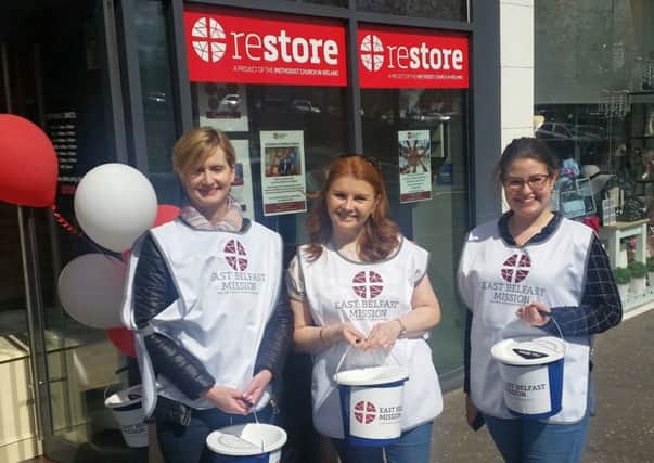 Volunteers collect outside the new Restore shop in Lisburn.