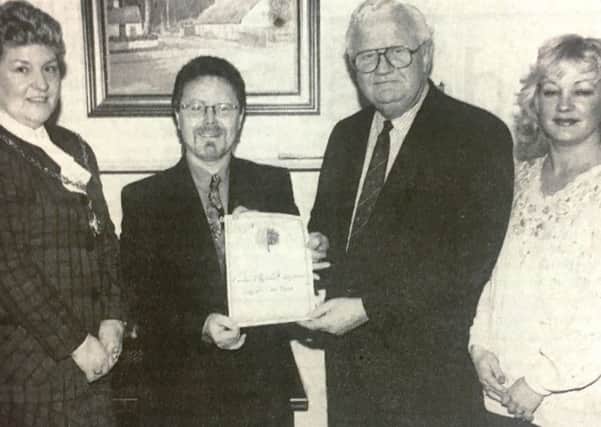 Mr Jimmy McIlwaine, director of NI 2000 presents Jim McCabe, secretary of CORE, with an environmental excellence award in 1994 for their project of planting trees and flower bulbs around Craigavon lakes, Also pictured are  Craigavon Mayor Joy Savage and Loretta Graham, CORE Project Manager,
