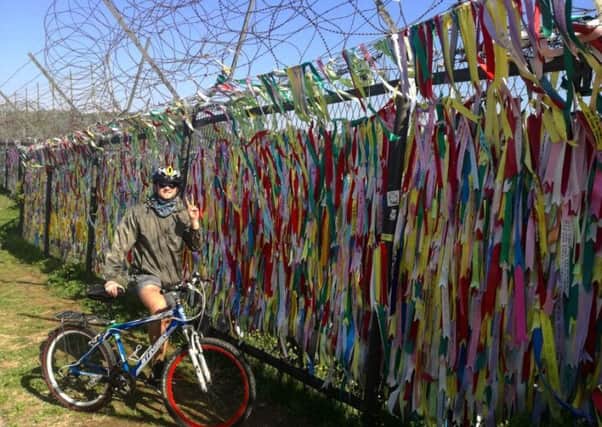 Matthew Redmond at the demilitarized zone in Korea just before he set off on his epic cycle.