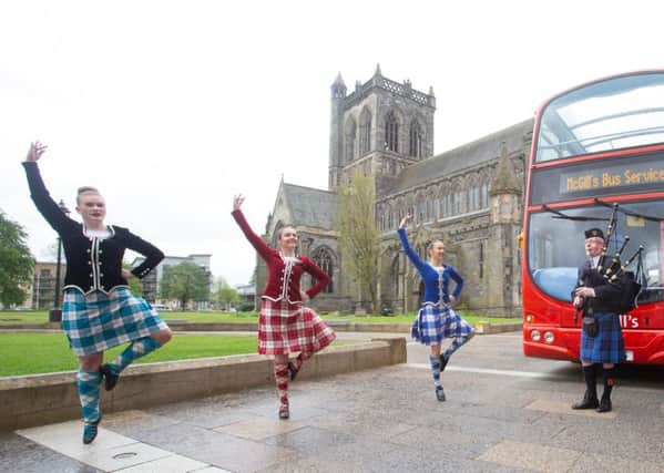 Highland dancers Eilidh Milne, Kirsty Gillies and Hope Brooke from the Christine Aitken Academy of Dance and piper Alan McGeoch from Johnstone Pipe Band give people a taste of what they can expect at the British Pipe Band Championships in Paisley on May 19. Pic by Mark F Gibson