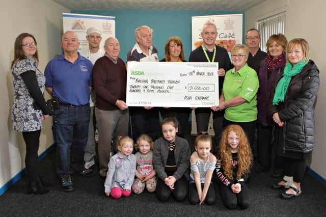 Image 1: Asda Coleraine General Store Manager Roy Warke and Asda Coleraine Community Champion, Sheila Palmer, are joined by Building Ballysally Together at the Asda Foundation cheque presentation for Â£21,550. L-R: Jenny Archer, Neighbourhood Renewal Officer with the Council; Gilbert Leighton of Blinds Galore; Chef, Brian Johnston, from Building Ballysally Together; Chair, Lexi Halliday and Treasurer, Adrian Eakin; ASDA People Training Manager, Louise Kane; Asda Coleraine GSM, Roy Warke and Asda Coleraine Community Champion, Sheila Palmer; and from the Housing Executive, Eddie Breslan, Nuala McGoldrick and Caroline Scott.