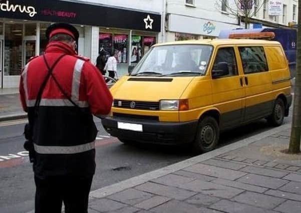 A traffic warden on the look-out for anyone committing parking offences. (Archive pic)