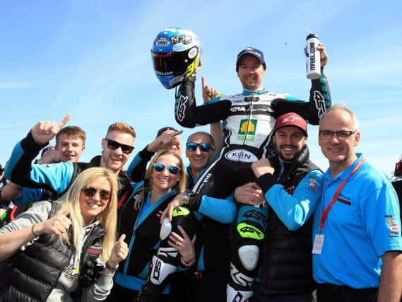 Alastair Seeley celebrates his Supersport double with the EHA Racing team.