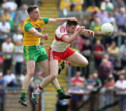 Derry's Emmet Bradley comes under pressure from Donegal's Ciaran Thompson in Celtic Park on Sunday. (Credit Â©INPHO/Lorcan Doherty)
