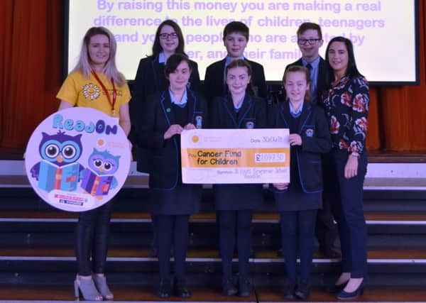 Pupils from St Louis Grammar School have raised a fantastic Â£1,067.00 for a local childrens charity by holding a sponsored reading event. Top fundraising pupils presented a cheque to Cancer Fund for
Children after completing the charitys ReadOn challenge.