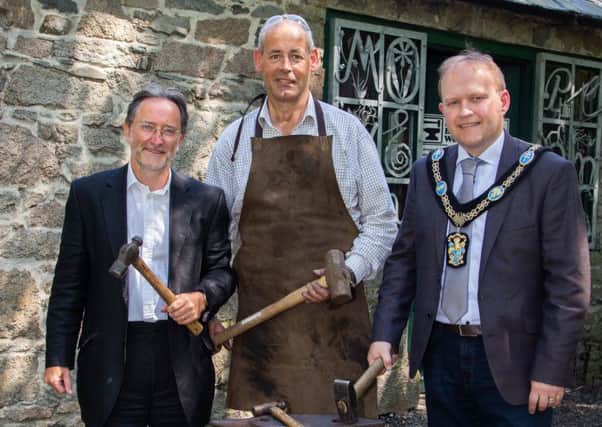 Pictured: Lord Mayor of Armagh City, Banbridge and Craigavon, Alderman Gareth Wilson, with Heritage Lottery Fund NI Committee Member Jim McGreevy and resident Blacksmith James McCullough.