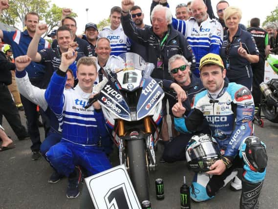 Michael Dunlop celebrates his Superbike TT victory on Saturday with the Tyco BMW team.