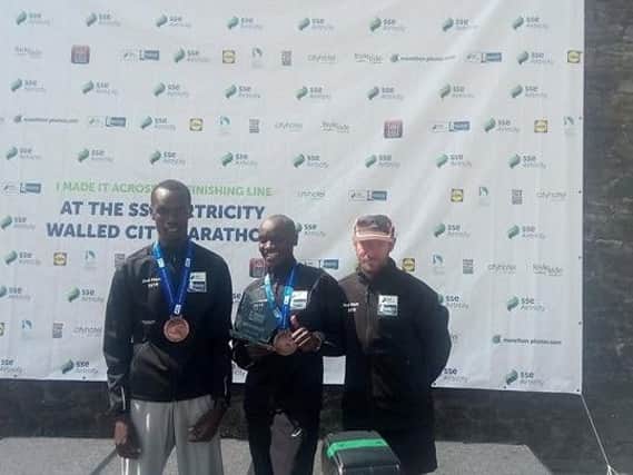 The top three male finishers in the 2018 Walled City Marathon, left to right, Eric Keoch (second), Dan Tanui (winner) and Thomas Maguire (third).