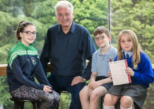Poet Frank Galligan is pictured taking to students Isobella McCrudden (9) fram St Theresa's P.S , Belfast,  Jonathan Graham (10), Antertaine.P.S, MAghera and Anna O'Connor, St Patrick's P.S Magehra at the closing event.  Picture by Brian Morrison.