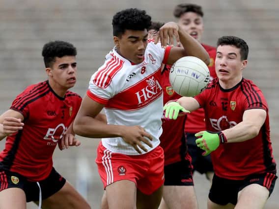 Callum Brown takes on Down's Finn McIlroy and Daniel Guinness in Clones.