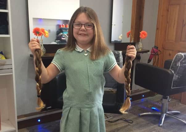 Demi-Leigh Scullion shows off the hair she is donating to the Little Princess Charity.