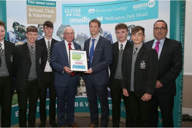 Richard Carey is pictured receiving the Post-Primary award from Ulster Council Vice-Chairman Oliver Galligan with Dominican College Vice-Principal, Mr Gerry Lynch (right) and team volunteer Richard Carey Snr (left).
