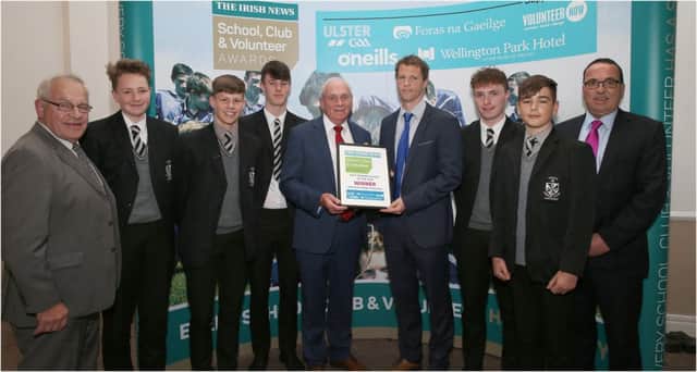Richard Carey is pictured receiving the Post-Primary award from Ulster Council Vice-Chairman Oliver Galligan with Dominican College Vice-Principal, Mr Gerry Lynch (right) and team volunteer Richard Carey Snr (left).