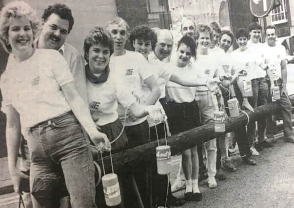 Northern Ireland Electricity employees helped to raise money for the 'Telethon' Appeal in 1988. Pictured are staff carrying a telegraph pole from the Portadown to Carn Industrial Estate.