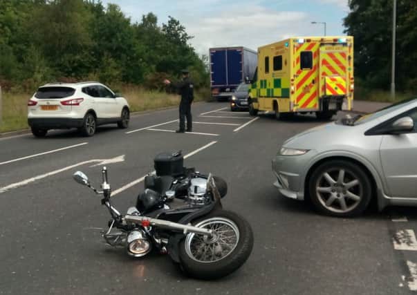Police direct traffic after a motorcycle was in collision with a car on the Charlestown Road, Portadown about 1pm on Wednesday 20 June 2018. An eyewitness said the motorcycle rider sat up on the road afterwards with a visible graze on his arm and was taken away by ambulance, pictured.