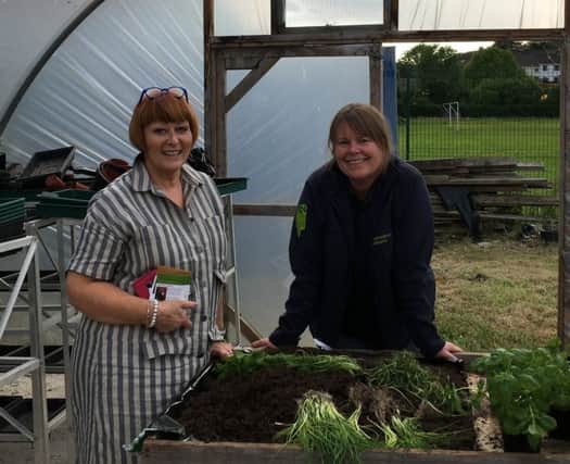 Bernie McKenna from Castlecaulfield Horticultural Society potting up a few herbs with Jenny McGetrick (TCV) at Castledawson Open Evening.