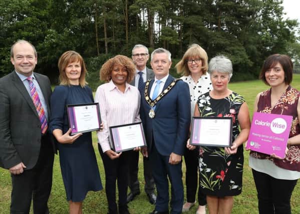 Mayor of Antrim and Newtownabbey, Councillor Paul Michael presents the Calorie Wise Award to Catering Managers Karen McLaughlin (Holywell Hospital), Marcia Ormiston and Geraldine Ward (Antrim Area Hospital) and Violet Davidson (Whiteabbey Hospital). They are joined by Dr Michael McBride, Chief Medical Officer, Dr Tony Stephens, Chief Executive, Northern Health & Social Care Trust, Sharon Gilmore, Food Standards Agency and Kathryn Wilson, Environmental Health Officer with Antrim and Newtownabbey Borough Council.
