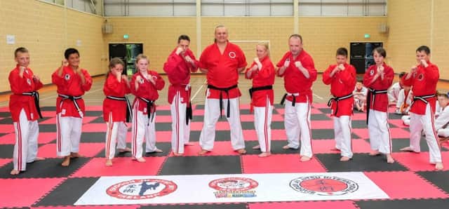 The Magnificent Seven! Shogun Ju-Jitsu Irelands new junior black belts in a Fighting Stance including Dominykas, Dylan, Molly, Charli, Eimantas, Adam and Cathair with Sensei Dan, Sensei Simon, Sensei Mandi and Sensei Paul.