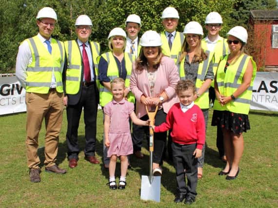 Cutting the sod on the new Woodburn Primary School building is Education Authority Chairperson Sharon OConnor and the schools youngest pupils, Charlotte and Lincoln. Also pictured are Cormac Murphy and Liam Murphy, Glasgiven Contracts; Annaleen Rea, Principal; Peadar Murphy, Education Authority; John Findlay, McAdam Design; Sharon Saunderson, Education Authority; John Herron, McAdam Design and Kathryn Menary, Department of Education.