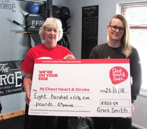 Valerie Saunders, Northern Ireland Chest Heart and Stroke receives a cheque for Â£855.59 from Ballymoney personal trainer Grace Smith who completed an eight hour Assault Bike challenge for the local charity.