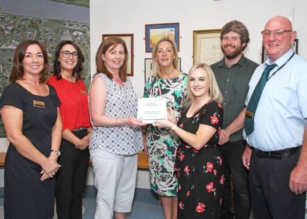 Orla Kelly (third from right), from Autism NI, presents a  Autism NI Impact Award to staff at the Tower Museum in Derry, in recognition of their continual  Autism Friendly  programme. From left are museum services staff members Sharon Glackin, Alison  Norris, operations manager, Betty Doherty,  Emma McGarrity, Ronan McConnell, education officer and Gerry Lynn.