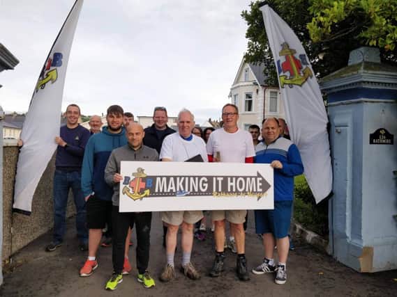 Lead walkers Rev Dr Trevor McCormick and Drew Buchanan MBE (front centre) with some supporters to wave them off at Rathmore House, Larne at the start of the 35 m walk to Newport in Culcavy.