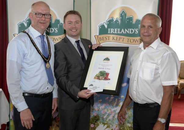 Banbridge is named Best Kept Urban Centre at the Ireland Best Kept Awards. Pictured recieved the honour are Deputy Lord Mayor, Paul Duffy, Simon Webb of the Department of Rural Economic Development and Eric Morton.