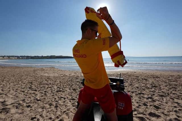 RNLI calls for public to swim between red and yellow flags as beach lifeguards rescue three teenagers caught in rip current.