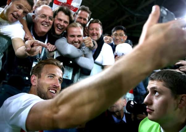 England captain Harry Kane snaps a selfie with fans after his teams victory over Colombia