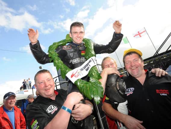 Chris Dowd and the CD Racing team hoist William Dunlop aloft after he won the second Supersport race at the Ulster Grand Prix in 2009 - his first four-stroke success at one of road racing's 'majors'.