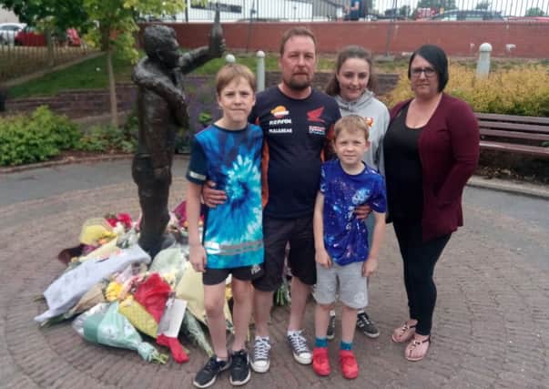 Racing fan Jim Neill from Lisburn with partner Julie Ann and children Jamie, 12, Alex, nine, and Amy, 14, at the Dunlop Memorial Gardens in Ballymoney