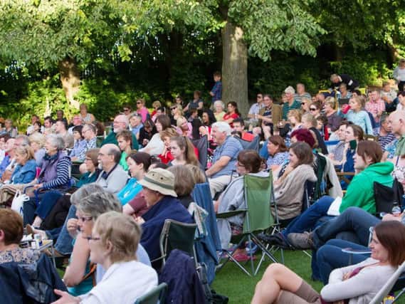 Crowds watch a performance of Twelfth Night in Shaftesbury Park, 2013.