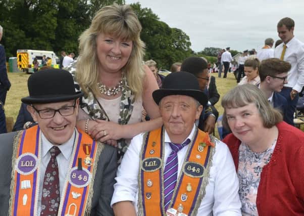 Councillor Frances Burton with Sidney Oliver, William Reid and Sandra Reid enjoying a sit-down in the field at Ballygawley