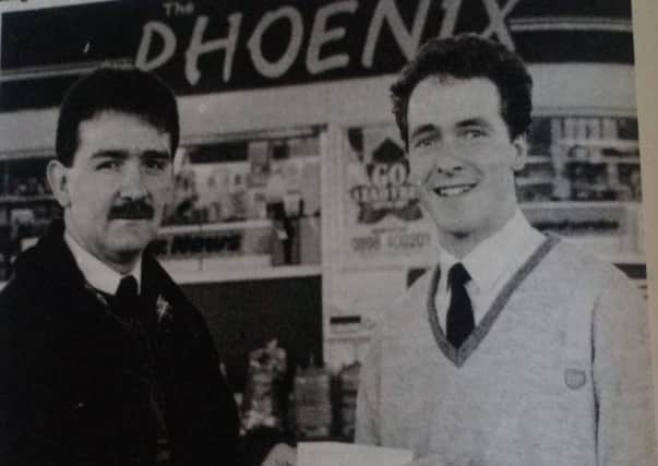 Peter McCool (right) of the Phoenix Filling Station presents a sponsors cheque to Joe McColl who receive the donation on behalf of Wakehurst  Football Club. 1989.