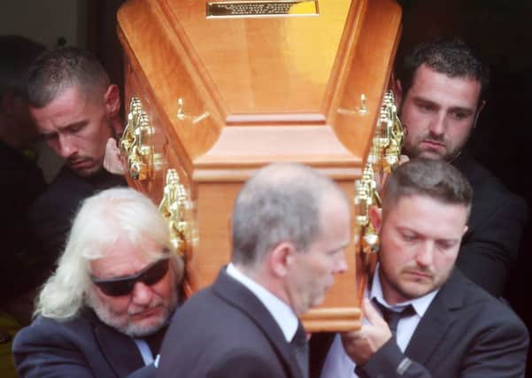 William Dunlops family, including his brother Michael (back right) carry his coffin from the church after the funeral