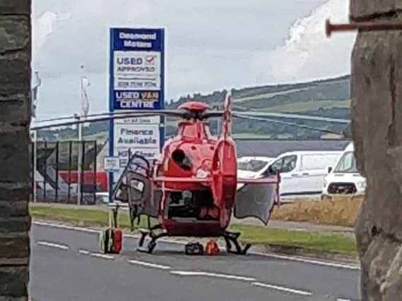 The air ambulance landed on Buncrana Road near Coshquin.