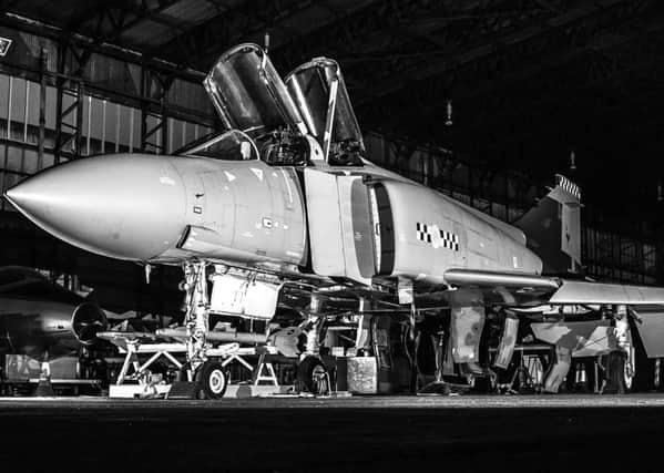 Night Time Phantom by Michael Carbery depicts a Phantom jet fighter in the midst of restoration by the UAS.