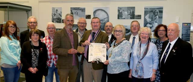 The Mayor of Causeway Coast and Glens Borough Council Councillor Brenda Chiver with members of Ballymoney RBL, Museum Services staff, Andrew Barrett who found the items and Kathleen Connolly, local family history researcher.