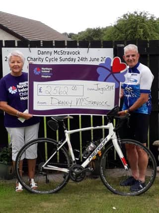 Danny McStravock presents a cheque for Â£2,562 to Emily Ferson, Magherafelt Support Group Chair.