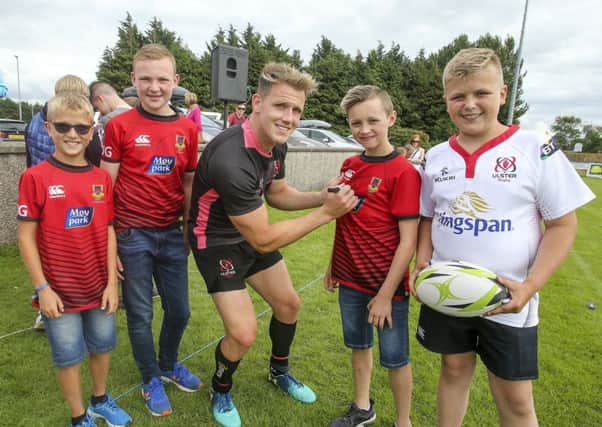 Craig Gilroy signs a few jerseys during the Ulster Rugby Away Day training at Coleraine