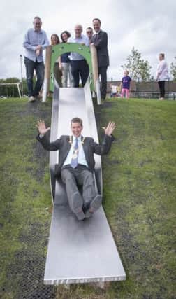 The Mayor of Derry City and Strabane District Council, Councillor John Boyle, pictured at the official opening of the new Invest in Play Playpark in Kilfennan on Tuesday afternoon trying out one of the slides.