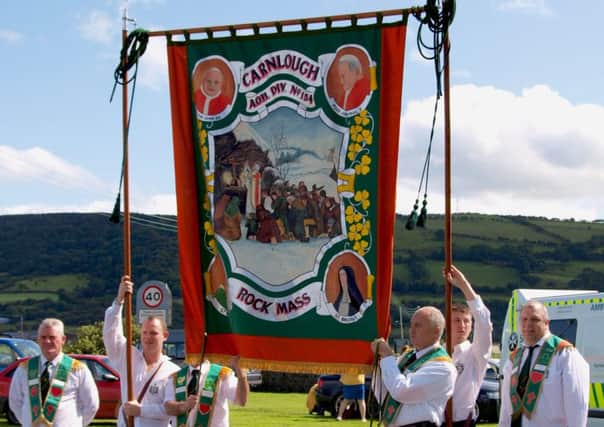 Members of the Carnlough AOH DIV 154 unfurl their banner to lead out the parade.  LT34-725-BM