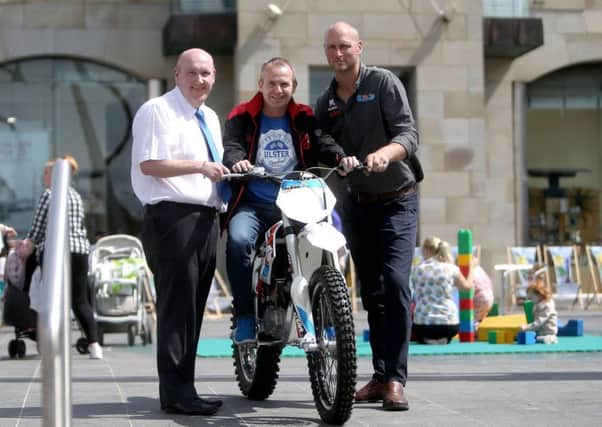 Alderman William Leathem, Chair of the Council's Development Committee with event organiser Geoff Wilson and Gareth George, Etrax promoting 'Old Meets New Bike event on Saturday 4th August, 1pm - 4pm, in Market Square, Lisburn.